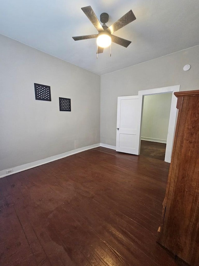 unfurnished room featuring baseboards, wood-type flooring, and ceiling fan