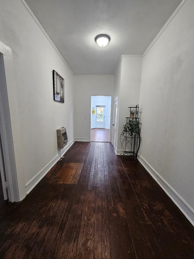 hallway featuring baseboards, hardwood / wood-style floors, crown molding, and a wall unit AC