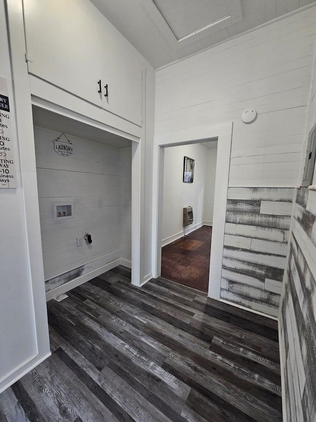 clothes washing area with baseboards, dark wood finished floors, hookup for a washing machine, heating unit, and cabinet space