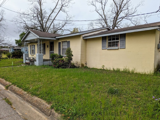26 Martin Luther King Dr, Headland, AL 36345 - single story home with concrete block siding, a porch, and a front lawn