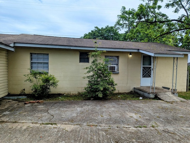26 Martin Luther King Dr, Headland, AL 36345 - rear view of property featuring concrete block siding, roof with shingles, and cooling unit