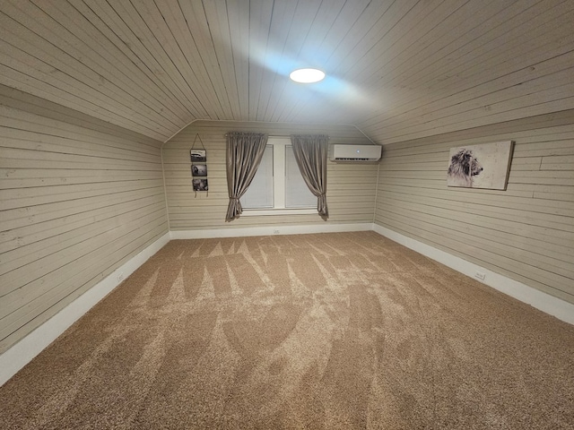 empty room featuring lofted ceiling, carpet flooring, a wall mounted AC, and wooden walls