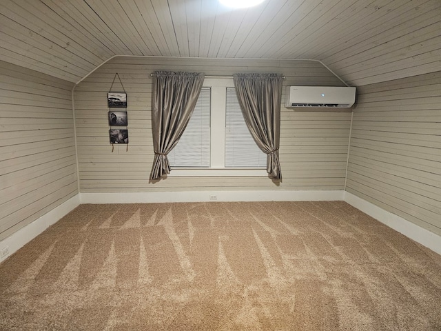 spare room featuring carpet, an AC wall unit, vaulted ceiling, and wood ceiling