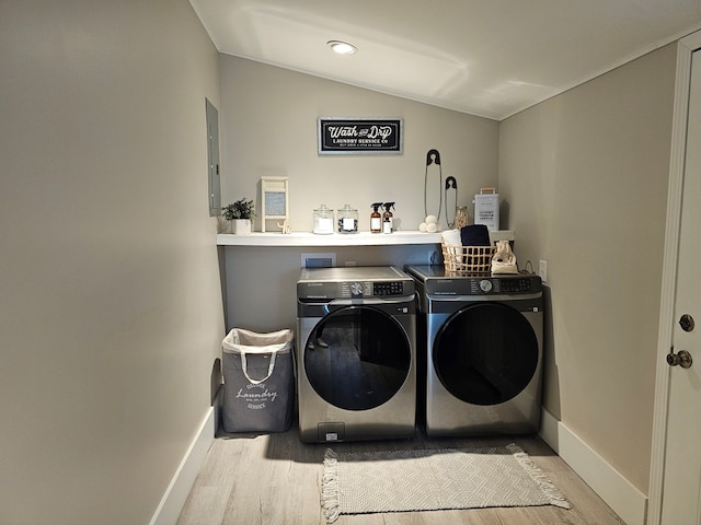 laundry area with light hardwood / wood-style floors and independent washer and dryer