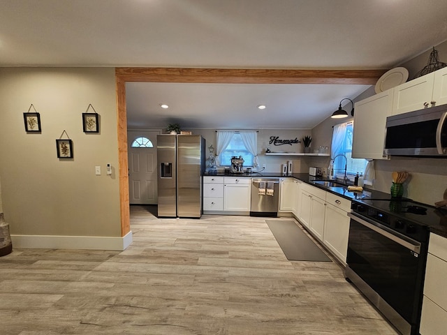 kitchen with light hardwood / wood-style floors, sink, stainless steel appliances, and white cabinetry