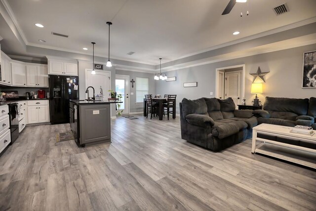 370 Airport Rd, Slocomb, AL 36375 - living room with light wood finished floors, ceiling fan, a chandelier, recessed lighting, and ornamental molding