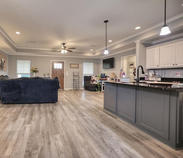 370 Airport Rd, Slocomb, AL 36375 - kitchen with open floor plan, a raised ceiling, white cabinetry, a ceiling fan, and decorative light fixtures