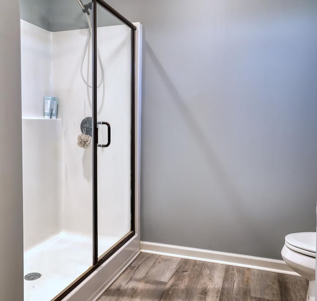 370 Airport Rd, Slocomb, AL 36375 - full bathroom featuring wood finished floors, a shower stall, toilet, and baseboards
