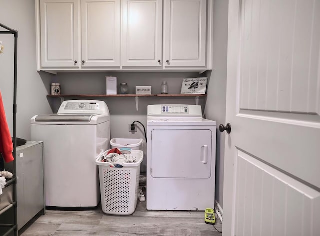 370 Airport Rd, Slocomb, AL 36375 - laundry room with cabinet space, light wood-style floors, and separate washer and dryer
