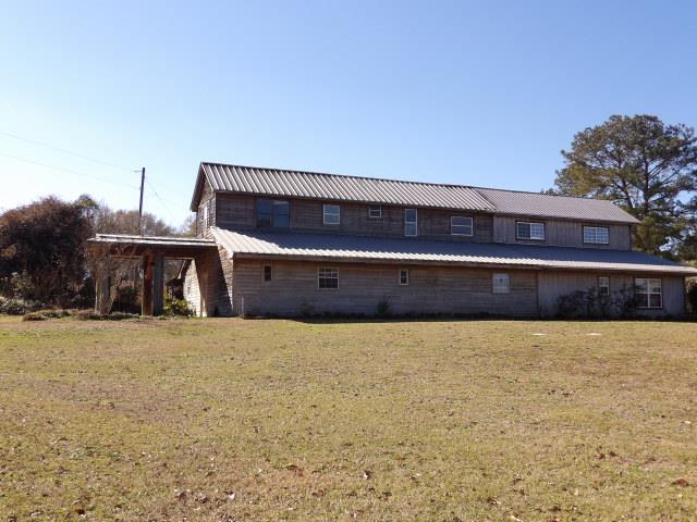 rear view of house with a lawn