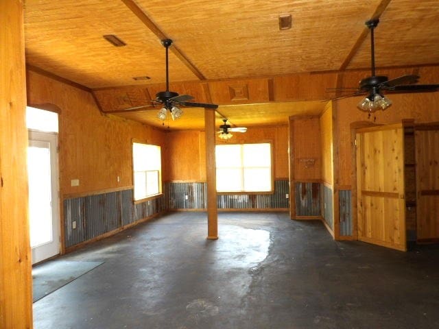 garage with wooden ceiling and wood walls