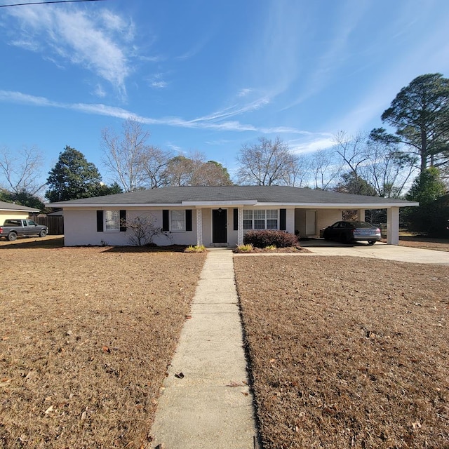 single story home with an attached carport, concrete driveway, and a front lawn