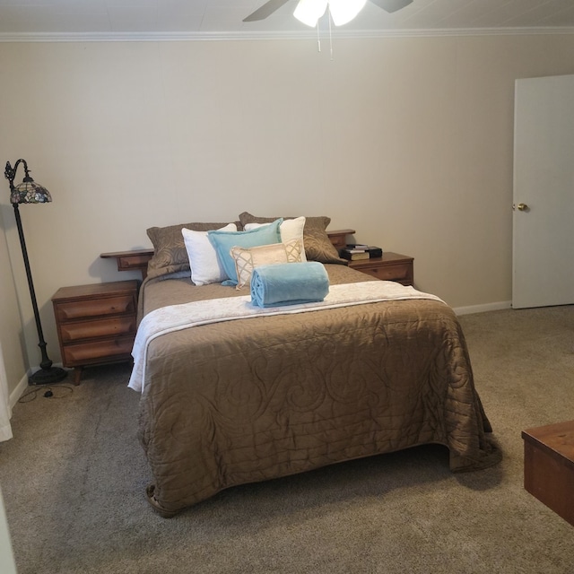 bedroom with baseboards, carpet, ceiling fan, and crown molding