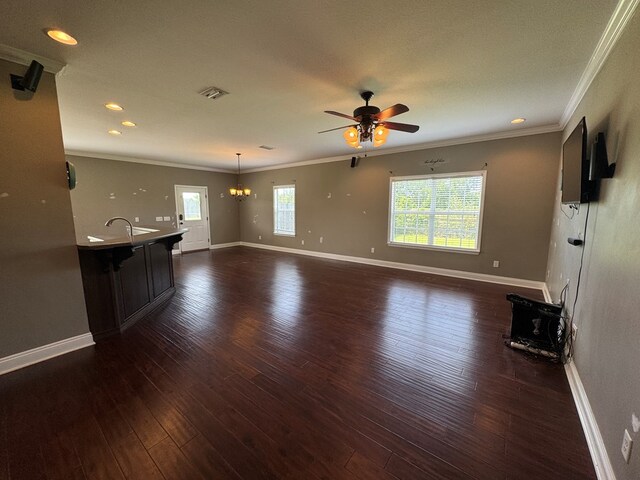 2103 Holland Rd, Newton, AL 36352 - unfurnished living room with ceiling fan, crown molding, a chandelier, dark wood-type flooring, and baseboards