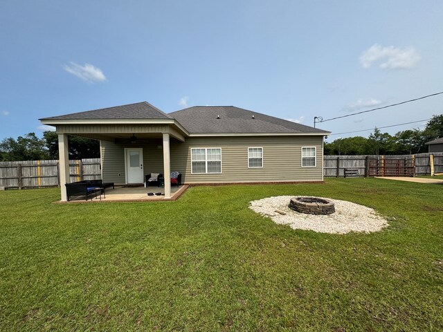 2103 Holland Rd, Newton, AL 36352 - back of property featuring an outdoor fire pit, a patio, and a shingled roof