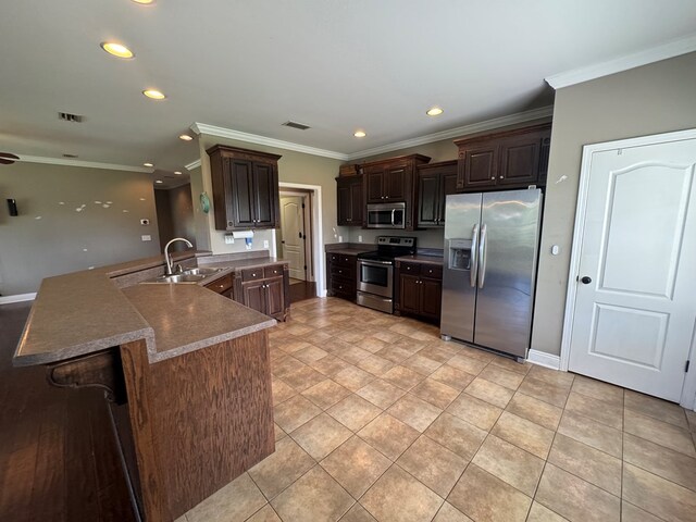 2103 Holland Rd, Newton, AL 36352 - kitchen with appliances with stainless steel finishes, a sink, crown molding, dark brown cabinetry, and recessed lighting