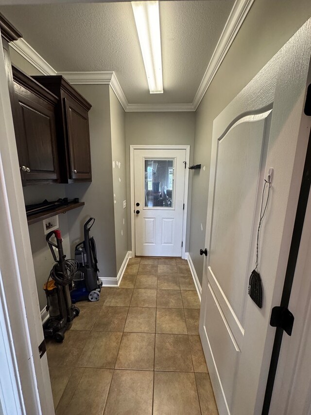 2103 Holland Rd, Newton, AL 36352 - entryway featuring ornamental molding, light tile patterned floors, a textured ceiling, and baseboards