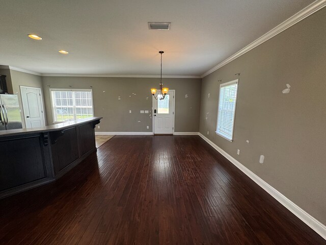 2103 Holland Rd, Newton, AL 36352 - unfurnished dining area with a chandelier, wood-type flooring, baseboards, crown molding, and recessed lighting