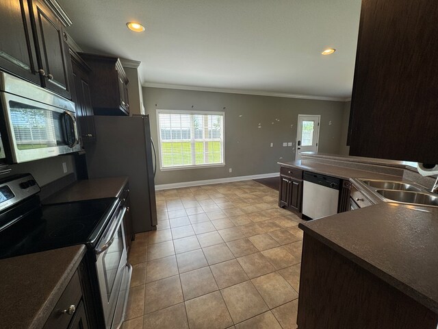 2103 Holland Rd, Newton, AL 36352 - kitchen featuring stainless steel appliances, a sink, crown molding, dark countertops, and light tile patterned floors
