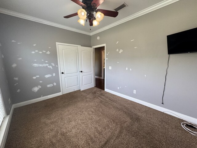 2103 Holland Rd, Newton, AL 36352 - unfurnished bedroom featuring carpet, crown molding, baseboards, and a ceiling fan
