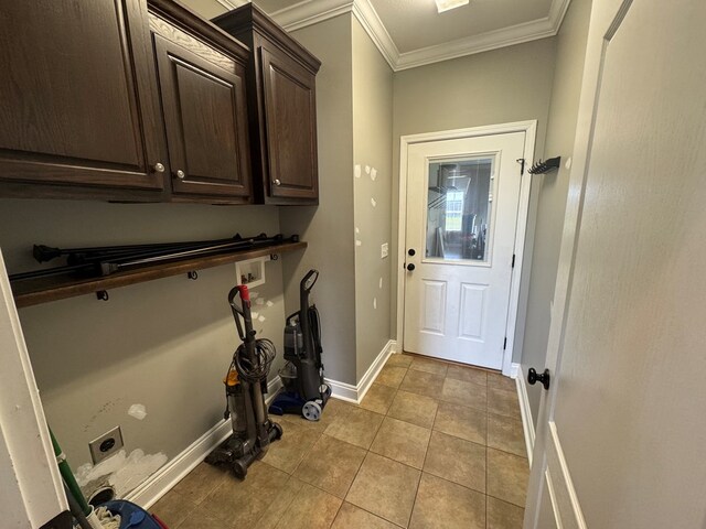 2103 Holland Rd, Newton, AL 36352 - washroom with hookup for an electric dryer, cabinet space, crown molding, light tile patterned floors, and hookup for a washing machine