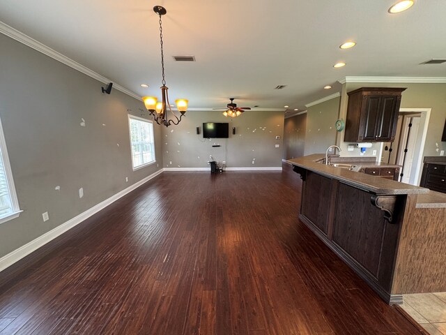 2103 Holland Rd, Newton, AL 36352 - kitchen featuring a chandelier, crown molding, dark brown cabinets, a breakfast bar area, and recessed lighting