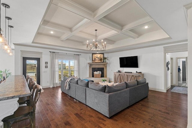 living area featuring crown molding, coffered ceiling, dark wood finished floors, and a fireplace