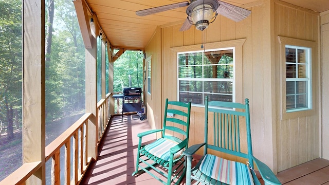 sunroom / solarium featuring ceiling fan