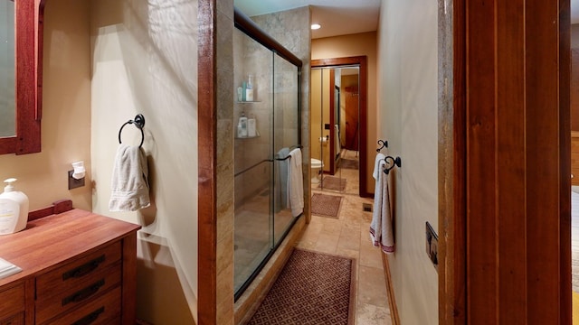 bathroom with a stall shower and toilet