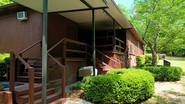 view of home's exterior with a wall unit AC