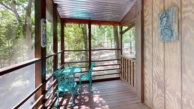 unfurnished sunroom with lofted ceiling