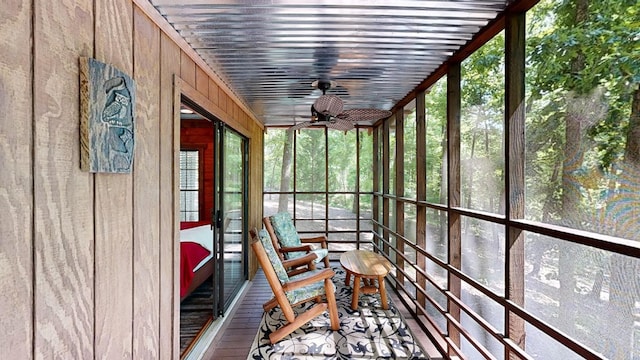 unfurnished sunroom with a ceiling fan
