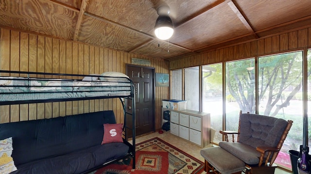 bedroom with wooden walls, multiple windows, and wood ceiling