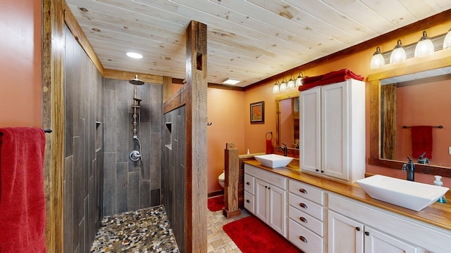 bathroom with double vanity, wooden ceiling, and a sink
