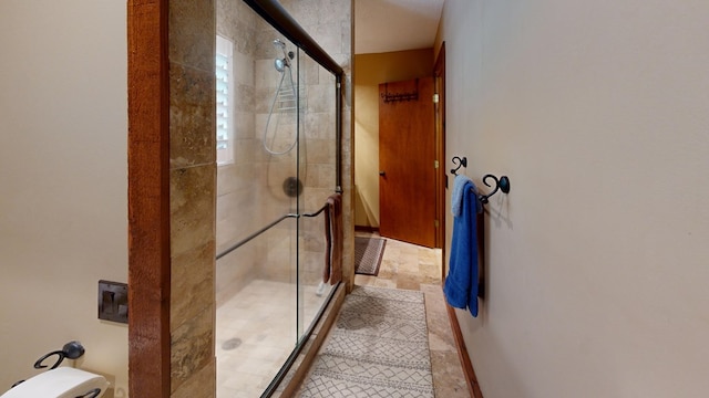 bathroom featuring a shower with shower door