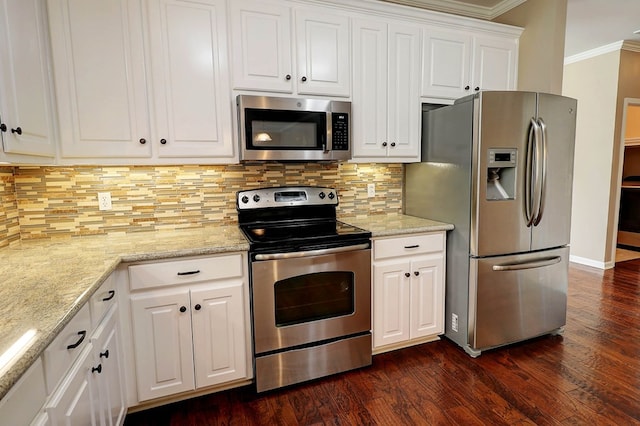 223 Veritas Dr, Dothan, AL 36303 - kitchen with appliances with stainless steel finishes, ornamental molding, dark wood finished floors, white cabinetry, and backsplash