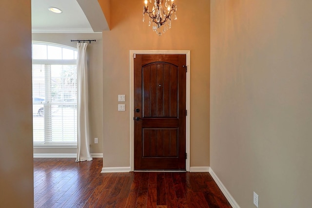 223 Veritas Dr, Dothan, AL 36303 - foyer entrance with ornamental molding, a chandelier, arched walkways, and wood finished floors