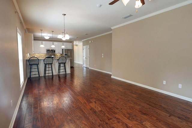223 Veritas Dr, Dothan, AL 36303 - living room with a ceiling fan, dark wood-style floors, a chandelier, and ornamental molding
