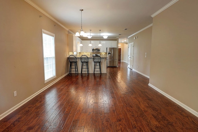 223 Veritas Dr, Dothan, AL 36303 - kitchen featuring appliances with stainless steel finishes, decorative backsplash, a kitchen breakfast bar, a chandelier, and dark wood-style flooring