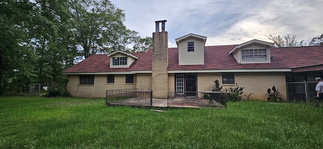 1594 Denton Rd, Dothan, AL 36303 - rear view of house with brick siding, a chimney, and a patio