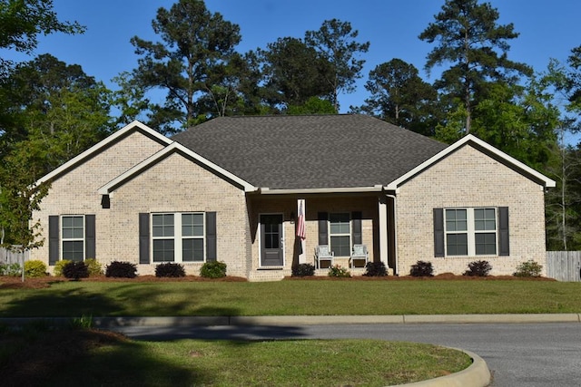 single story home featuring a front yard and brick siding