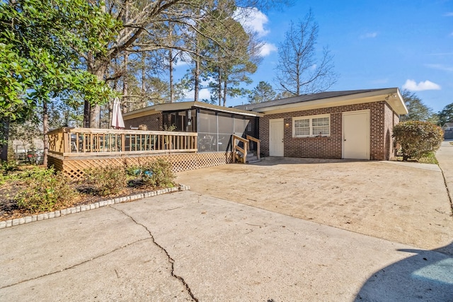 view of front of house with a deck and a sunroom