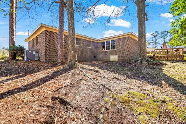 rear view of property with a wooden deck