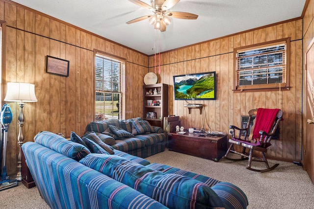 living room featuring wooden walls, light colored carpet, and ceiling fan