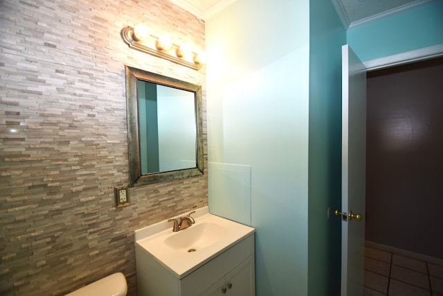 bathroom with vanity, tile patterned floors, ornamental molding, and toilet