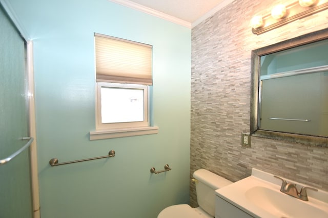 bathroom with crown molding, vanity, and toilet