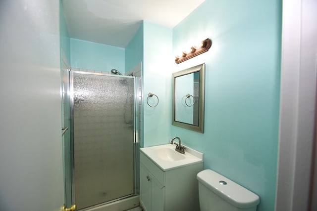 bathroom with vanity, toilet, and an enclosed shower