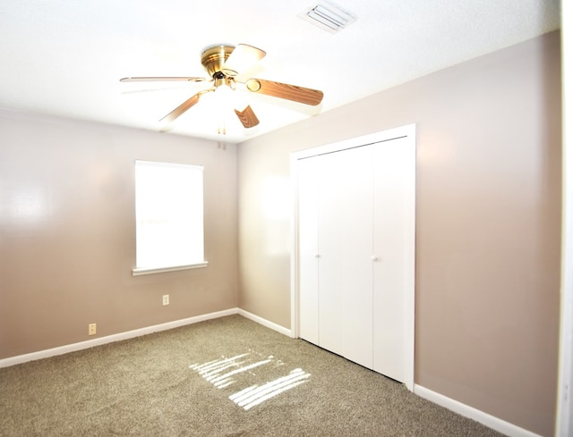 unfurnished bedroom featuring a closet, ceiling fan, and carpet flooring