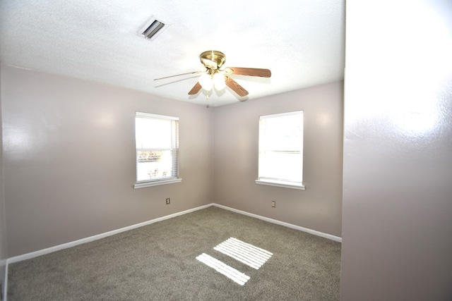 unfurnished room featuring ceiling fan, carpet floors, and a textured ceiling