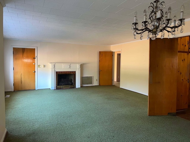 unfurnished living room featuring a chandelier, a fireplace, and carpet flooring